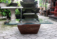An old rice mortar is the base for a unique glass table.
