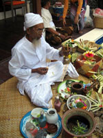 A Balinese priest is inaugurating a new house